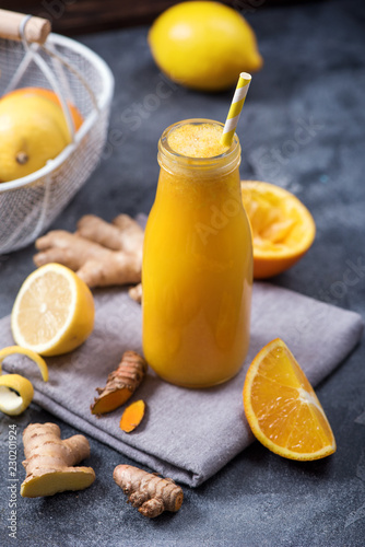 Citrus turmeric or curcuma drink with ginger, healthy detox vitamin juice