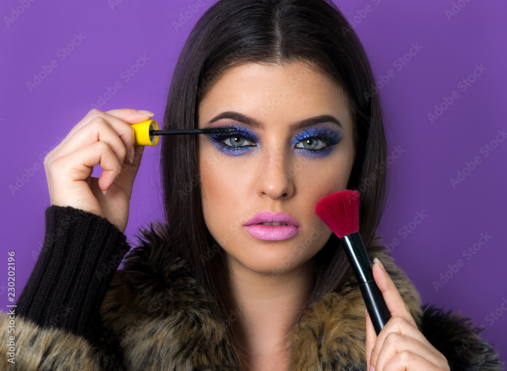 Make-up artist applying mascara and blush
