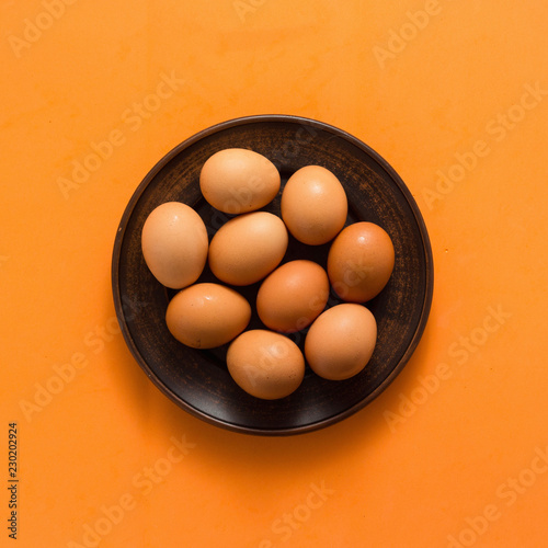 Egg, Chicken Eggs in plate on colored yellow background top view