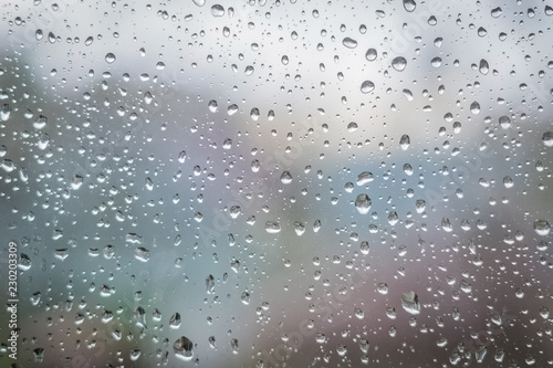 Rain drops on window glass. Abstract background texture. Selective focus