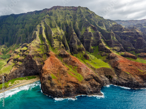 View of the monumental Na Pali Coast at Honopu valley, aerial shot from a helicopter, Kauai, Hawaii.