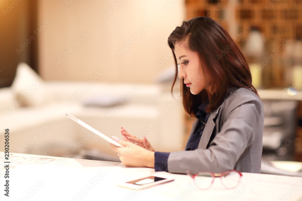 working and charming woman with glasses using tablet and cell phone (work from home concept) working and charming woman with glasses using tablet and cell phone (work from home concept)
