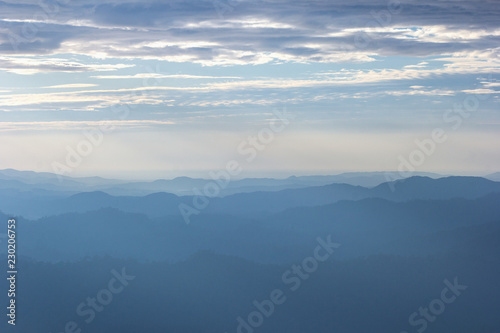 Beautiful view of the morning fog filling the valleys of smooth hills.