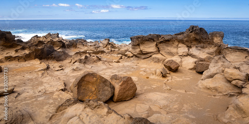 rugged rocky coast with some big boulders photo