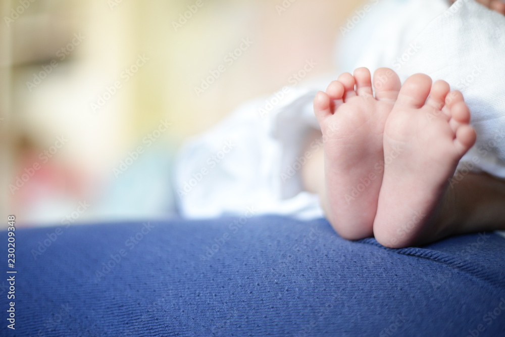 feet of newborn baby. small Baby feet resting on mother leg. soft smooth  skin of infant. baby sitting on mother lap. Stock Photo | Adobe Stock