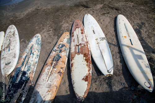 Windsurfing boards on the beach.