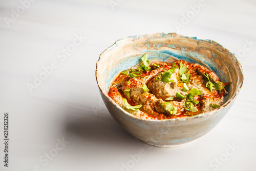 Middle Eastern cuisine: baba ganoush  in a plate on white background.