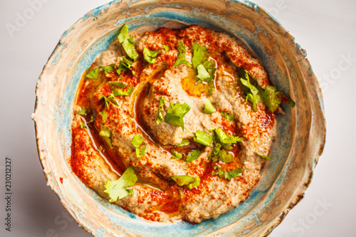 Middle Eastern cuisine: baba ganoush  in a plate on white background. photo