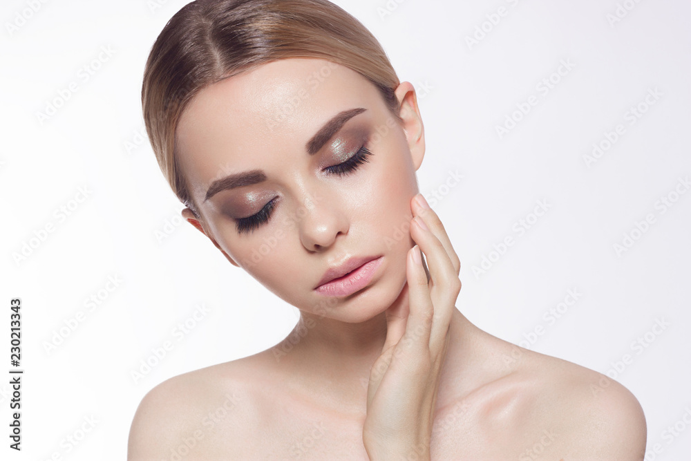 Fototapeta premium Lips Skin Care. Beautiful Woman With Beauty Face Applying Lip Balsam, Lipbalm On Full Sexy Lips. Portrait Of Smiling Female Model With Soft Skin And Natural Nude Makeup Touching Lips. High Resolution