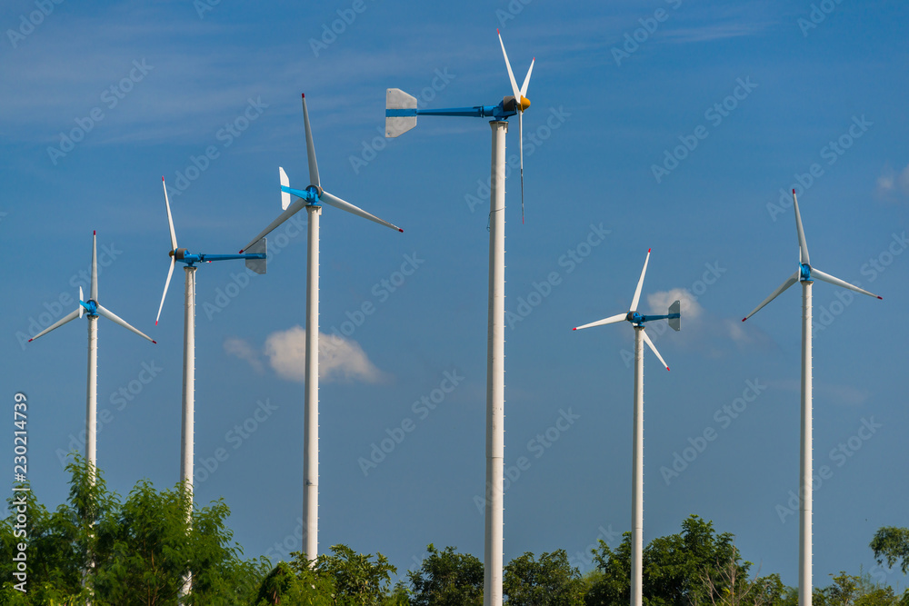 Fototapeta premium Windmills for electric power production in Royal Initiative Project Chang Hua Mun project demonstrate holistic agriculture for sufficient economy at Hua Hin district Phetchaburi, Thailand