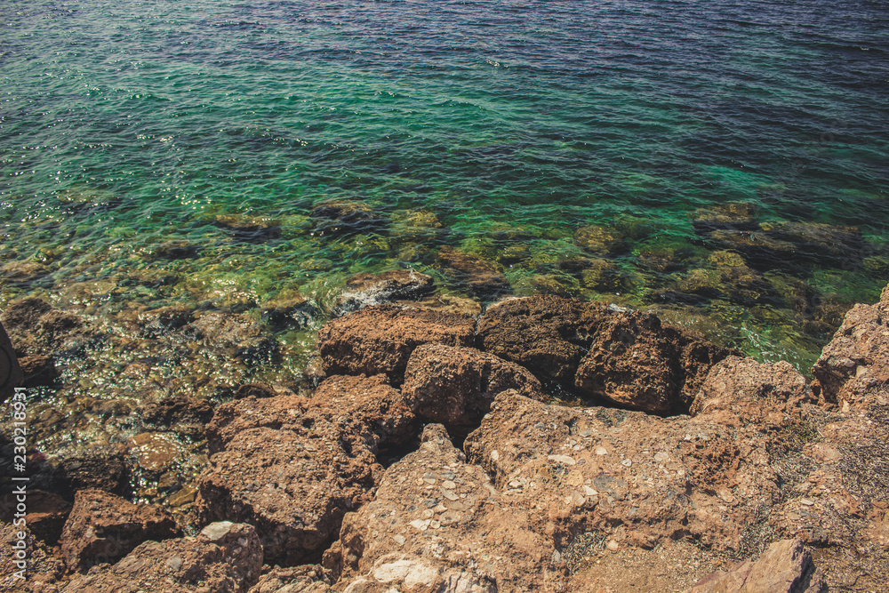 stones and rocks under water surface with waves of warm south tropic sea, foreshortening from above stones and rocks under water surface with waves of warm south tropic sea, foreshortening from above