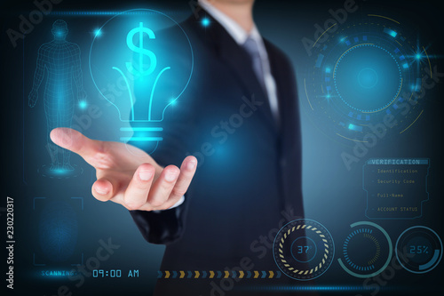 Businessman holding the glowing dollar bulb with futuristic technology background as business, innovation, intelligent, idea, income and investment concept