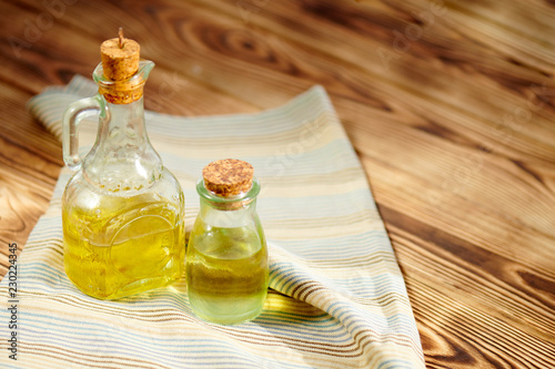 Olive oil in a bottle on wooden table