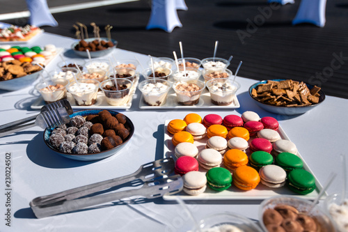 Assortment of tasty appetizers - canapes, cookies on the white tablecloth