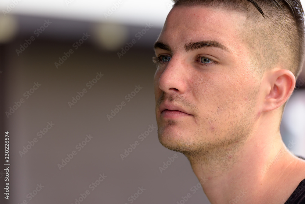 Fototapeta premium Close up of young handsome man thinking while looking at distanc