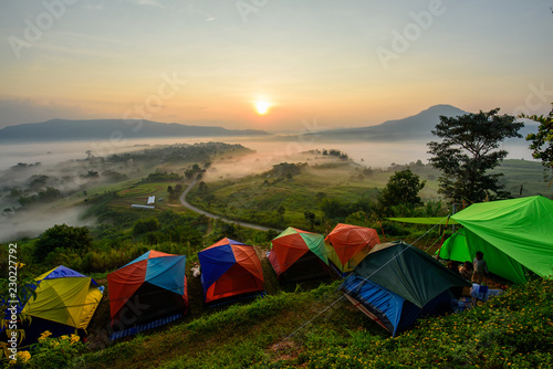 camping on high mountain with mist in sunrise time