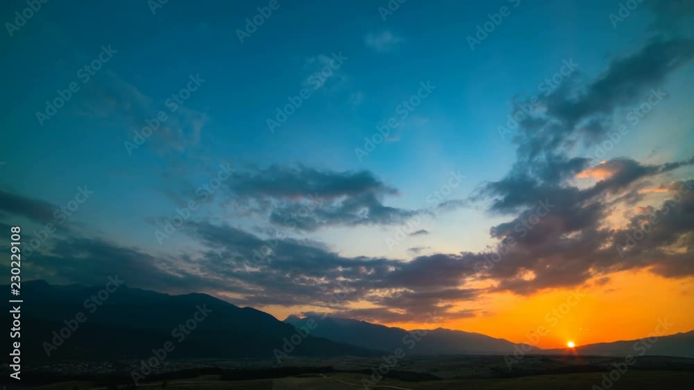 The picturesque sunset above the mountain. day to night time lapse