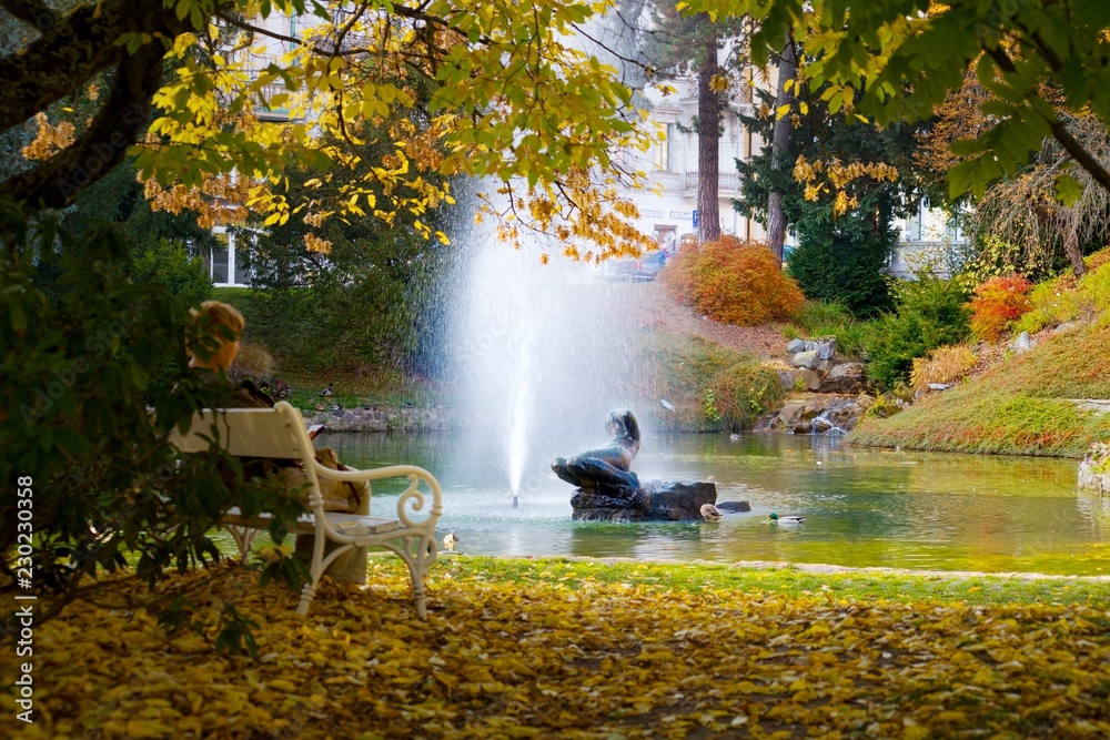 Autumn in central spa park - small lake with statue and fountain in Marianske Lazne (Marienbad) - great famous Bohemian spa town in the west part of the Czech Republic (region Karlovy Vary)