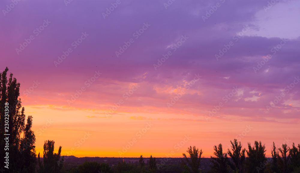 Obraz premium Landscape with dramatic light - beautiful golden sunset with saturated sky and clouds.