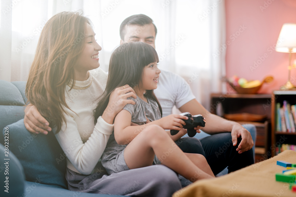 little girl and parent family playing video game at home little girl and parent family playing video game at home