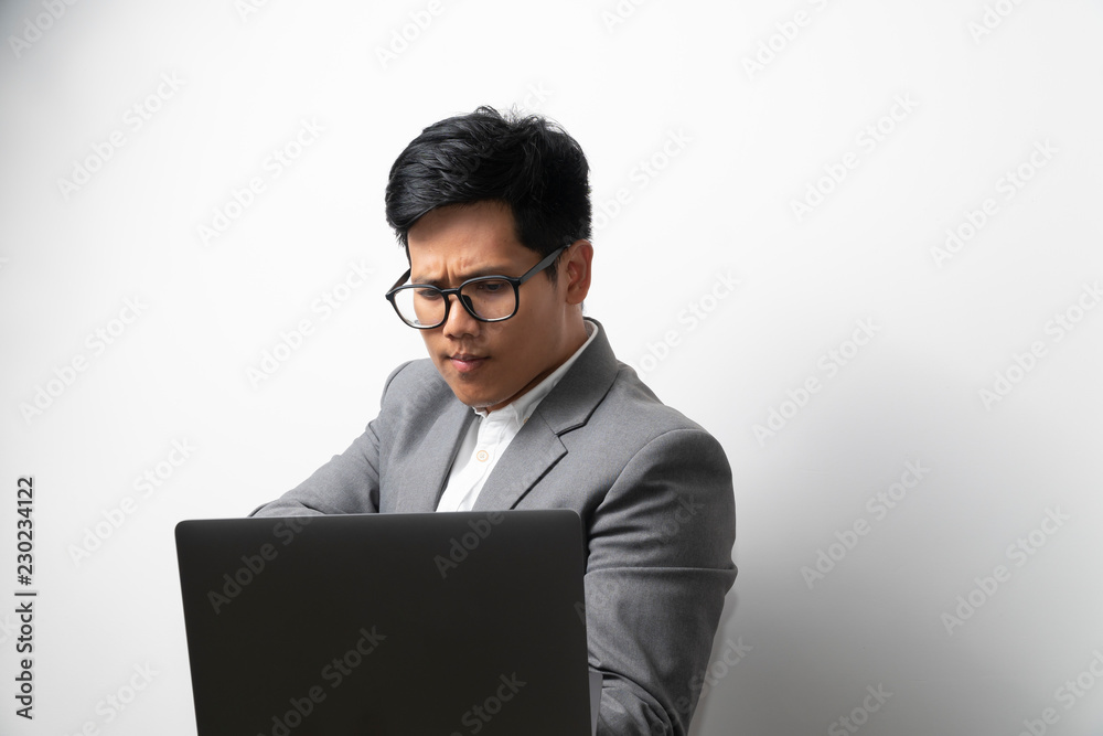 A man is making serious face while looking at laptop computer. Considering something. A man is making serious face while looking at laptop computer. Considering something.