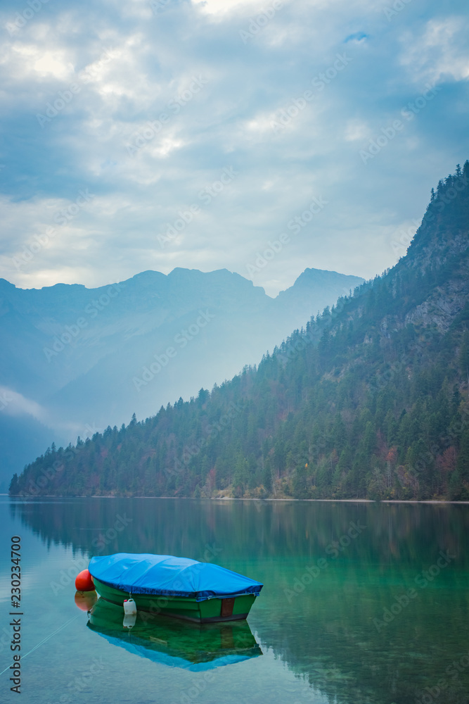 Small boat on lake Plansee in the European Alps, in Austria at early morning
