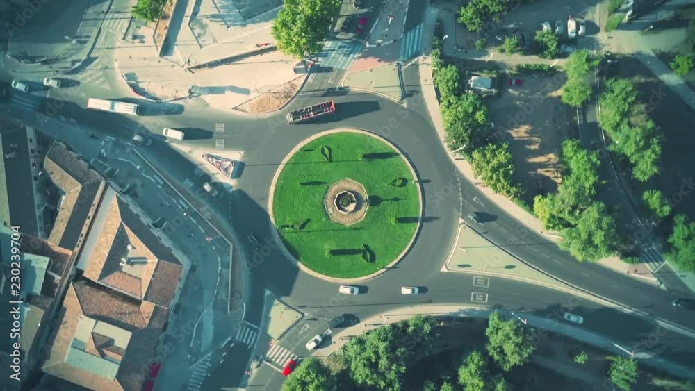 Aerial top down time lapse of roundabout traffic in Spanish town