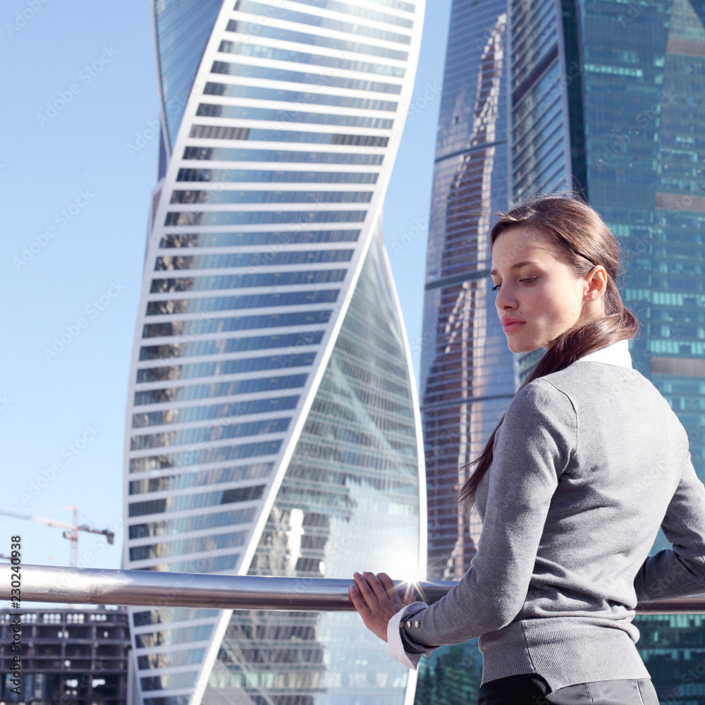 Businesswoman at skyscraper background Businesswoman at skyscraper background