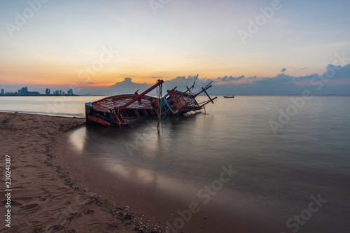 Shipwreck on the beach at sunset