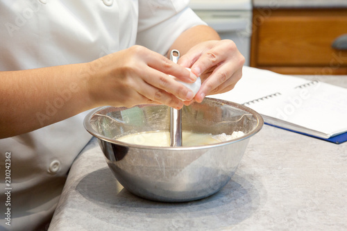 Cracking egg into mixing bowl