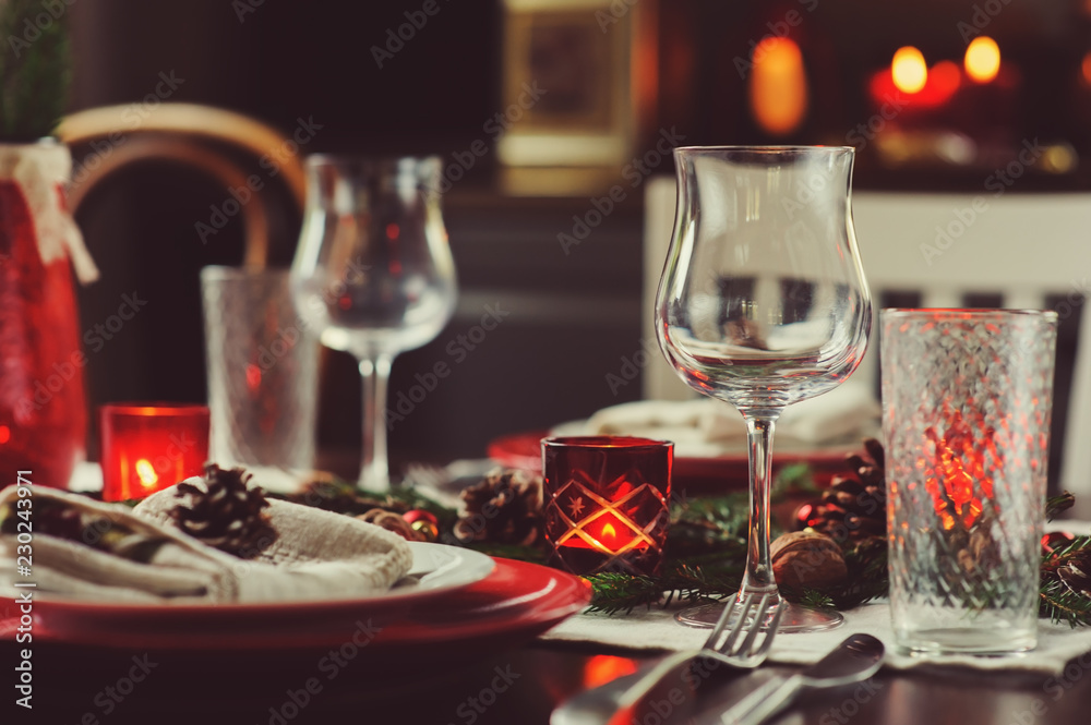 Table setting for celebration Christmas and New Year Holidays. Festive traditional red and green table at home with rustic details