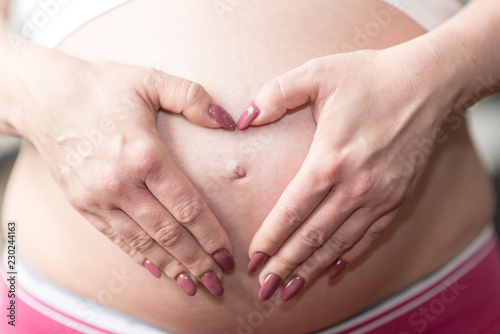 Wallpaper Mural Pregnant belly with hands in heart shape Torontodigital.ca