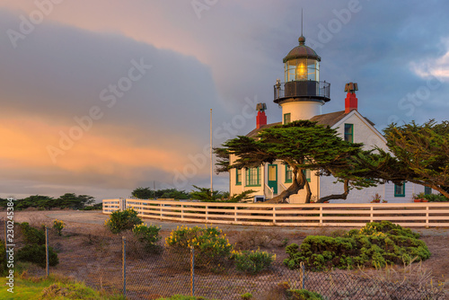 California lighthouse with dramatic sky. Point Pinos lighthouse  at sunset in Pacific Grove, Monterey, California. photo