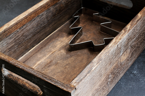 Christmas tree cookie cutter in wooden box, high angle view, copy space