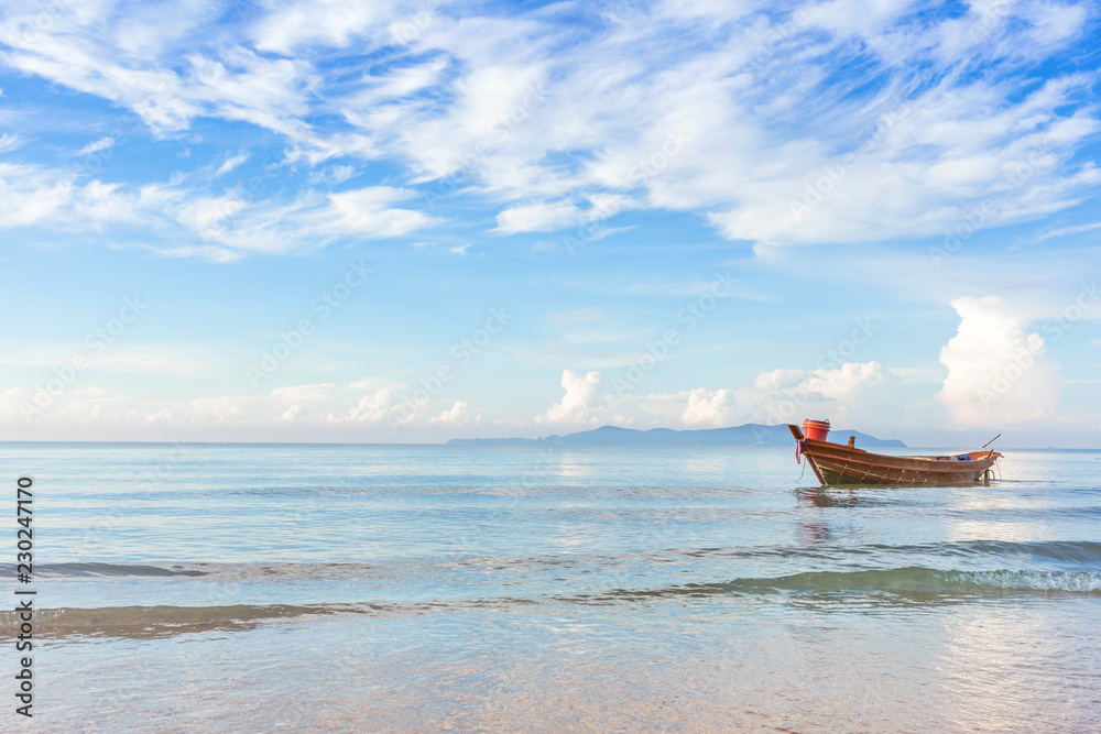 beautiful beach in morning sunrise and cloudy blue sky with fisherman boat