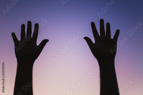 silhouette of two hands against sky
