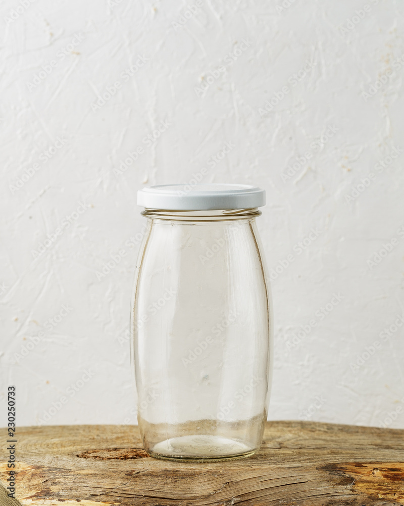 Empty glass jar on rustic wooden table Empty glass jar on rustic wooden table
