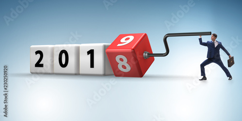 Businessman employee rotating cube to reveal number 2019