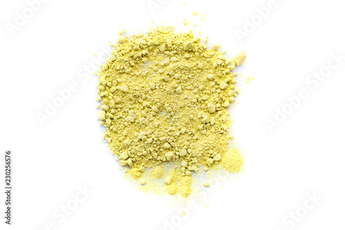 Yellow color background of chalk powder. Yellow color dust particles splattered on white background.