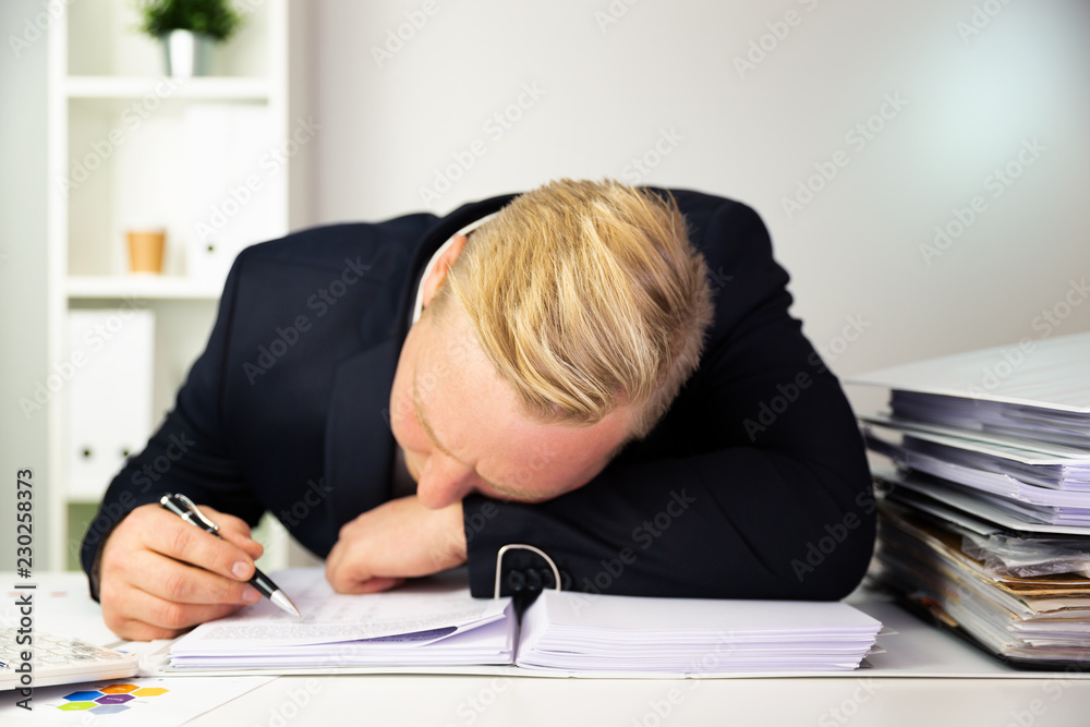 Businessman in a dark blue suit calculating sales results. Finance accounting concept Businessman in a dark blue suit calculating sales results. Finance accounting concept