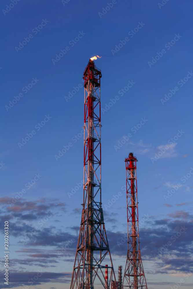 industrial flare for the combustion of associated petroleum gas against the background of sky