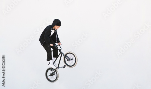 BMX freestyle. Young BMX bicycle makes tricks on the white background. Copyspace7 Bmx trick on a white background