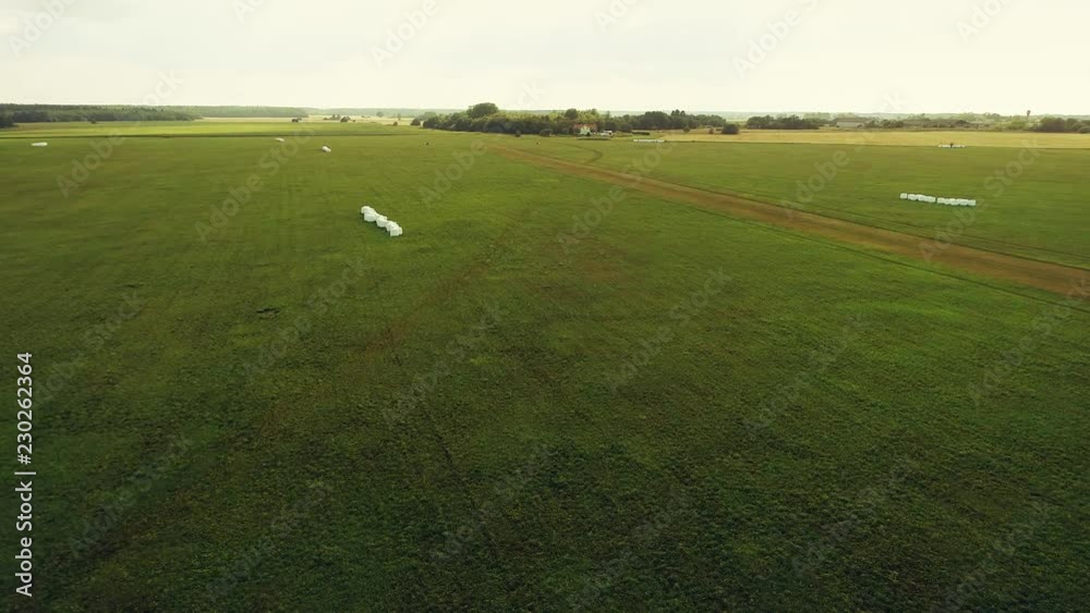 Aerial view of meadows, clouds over green meadows. Stunning aerial shot over lush green fields and meadows in the countryside, Shadows from clouds on green fields. Aerial footage. Aerial view of meadows, clouds over green meadows. Stunning aerial shot over lush green fields and meadows in the countryside, Shadows from clouds on green fields. Aerial footage.