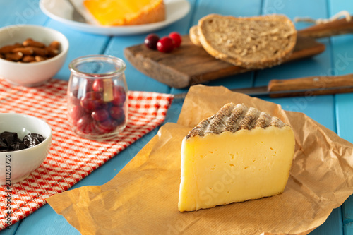 Tomme de monatgne type of cheese together with the addition of bread, fresh cranberries, almonds…