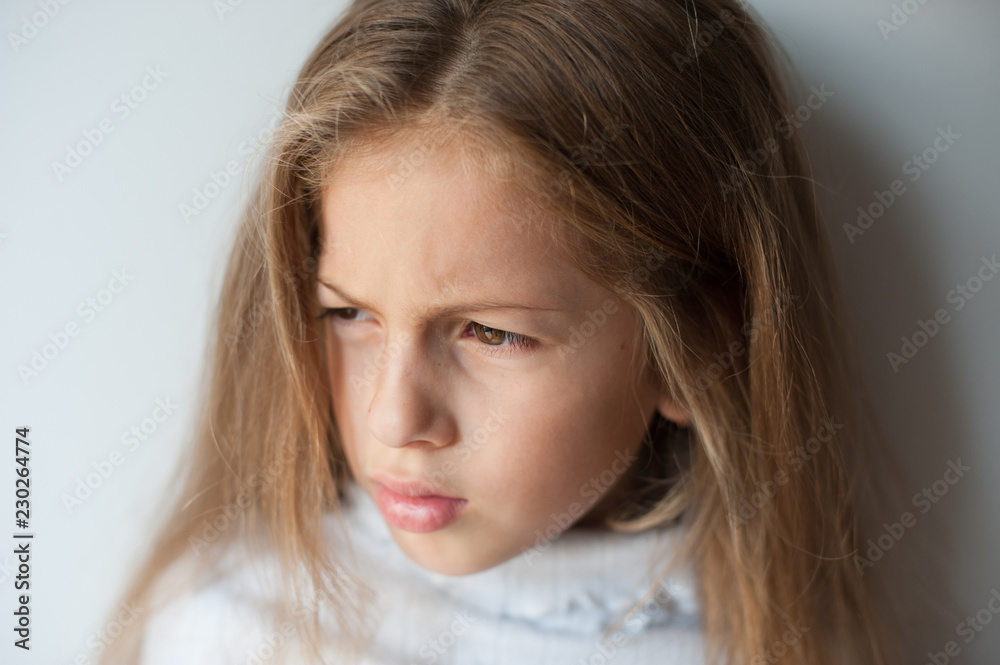 closeup portrait of real upset little caucasian girl with long hair closeup portrait of real upset little caucasian girl with long hair
