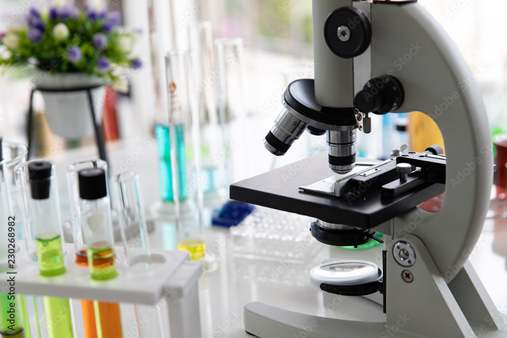 Microscopes and test tubes For scientific research in the chemistry laboratory on the table.