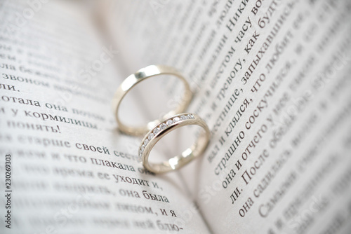 wedding rings on the open book