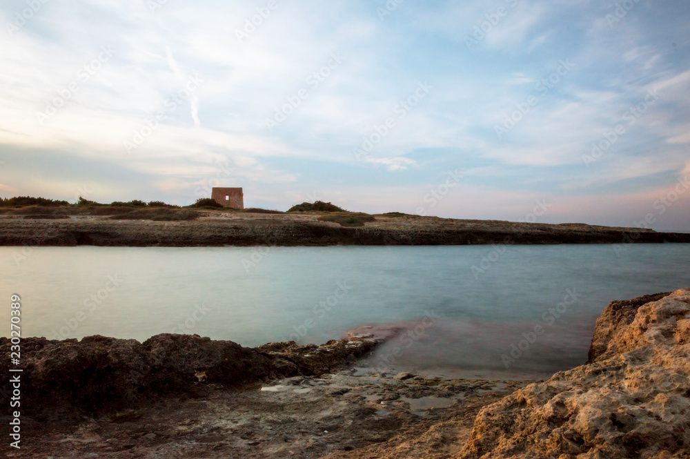 Torre Pozzelle beach and its bay at sunset in Ostuni Salento Italy