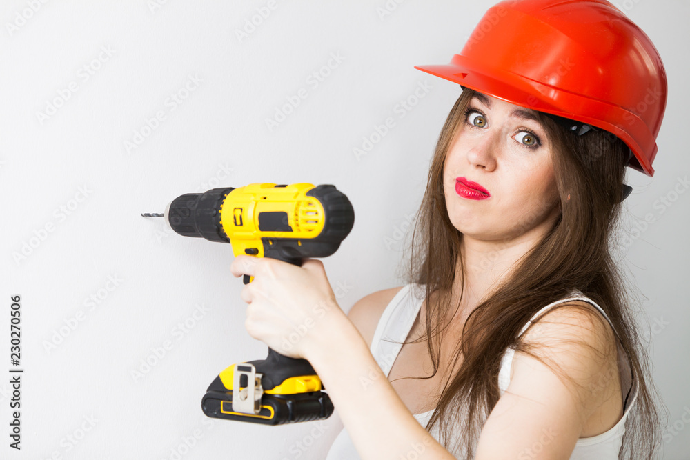 Tired woman using power driil for work at home Tired woman using power driil for work at home