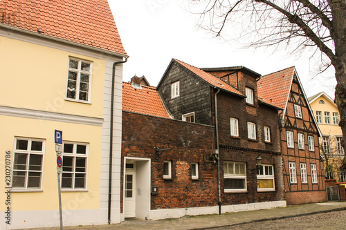 Luneburg, Germany - 10.12.2017: Medieval traditional European houses on stone pavement. Winter in Europe